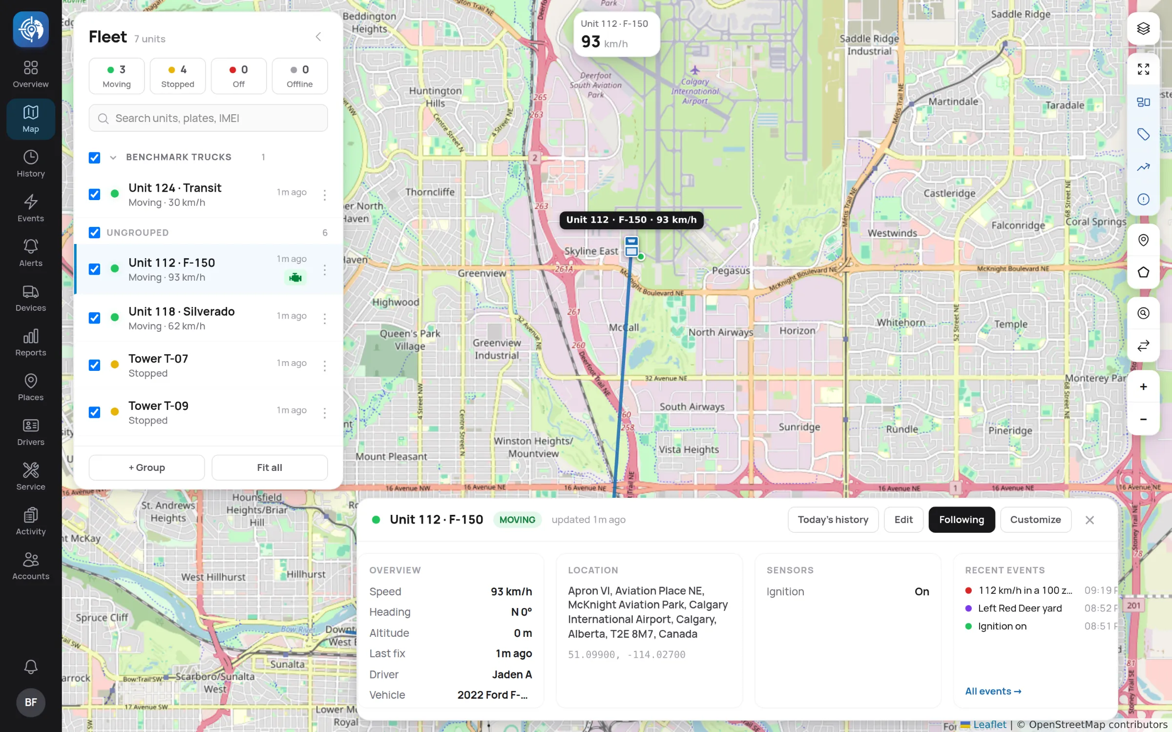 A unit selected on the live map with its speed, address, driver and recent events.